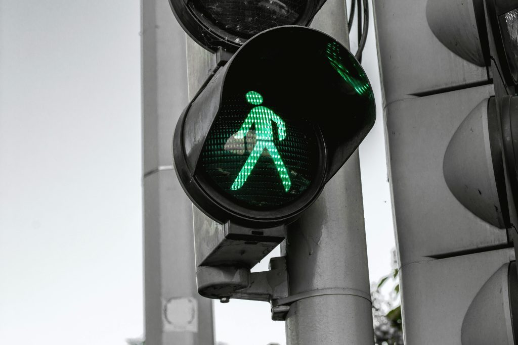 a man walking when this light on road